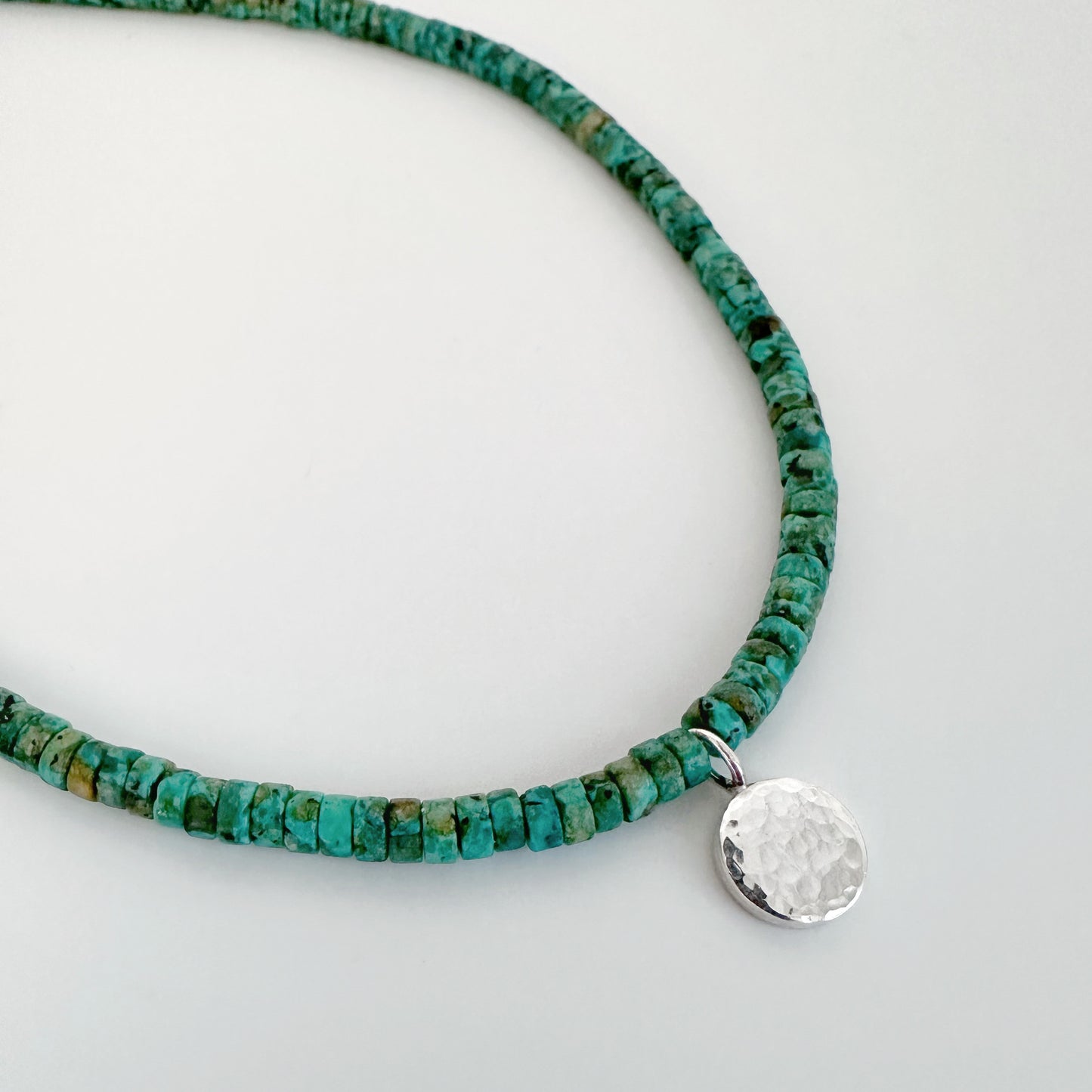 African Turquoise Bead and Hammered Silver Charm Necklace